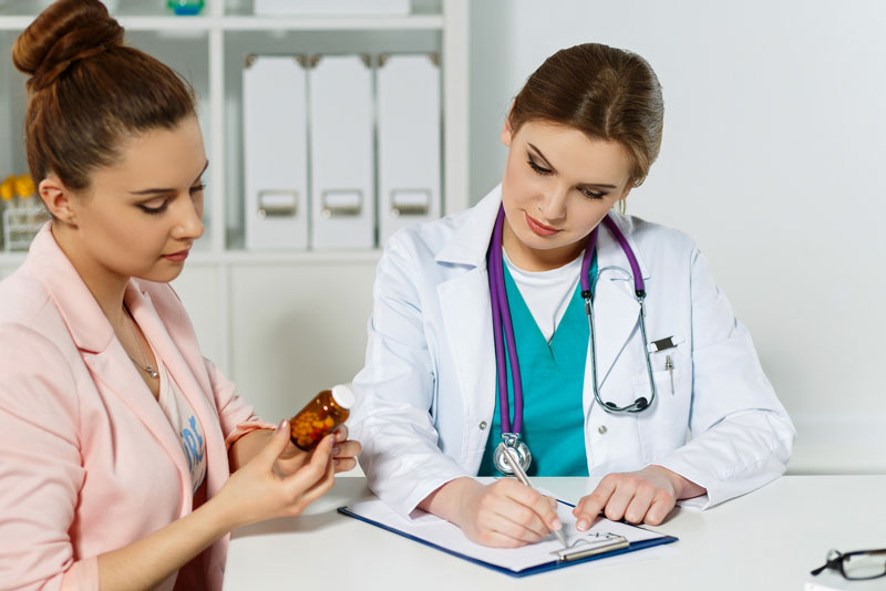 Physician-Writing-Prescription Doctor sharing information