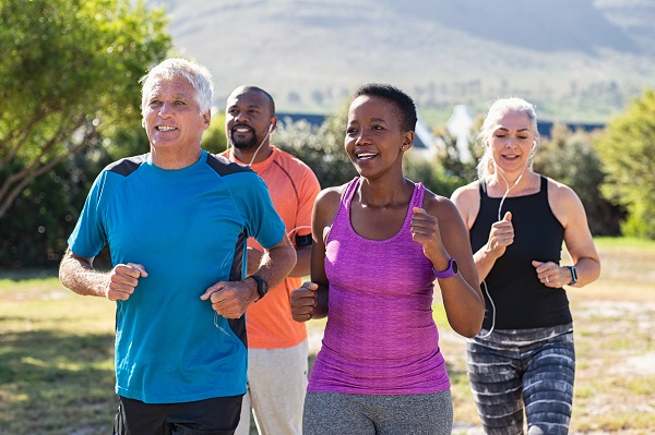 Mature and senior people jogging at park Extended Family Group Playing Board Game At Home